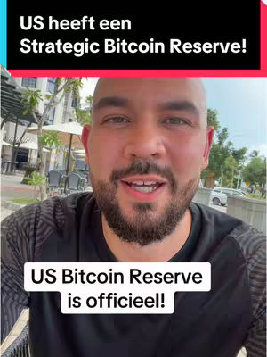 A man with a beard is centered in the image, looking at the camera while speaking. Above him, a black banner displays white text, and below him, a white text box provides additional information, indicating a news-related setting. The composition employs a medium shot, with the background blurred enough to focus on the man. Overall, suggests a news or information-focused video.