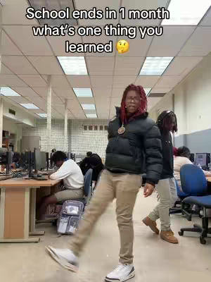 The cover photo shows a young man in a school setting. He is wearing a black puffer jacket, tan pants, and white sneakers. He has long red hair, and he is standing with one leg extended forward. The background includes other students and a school library, with computer desks and fluorescent lights.
