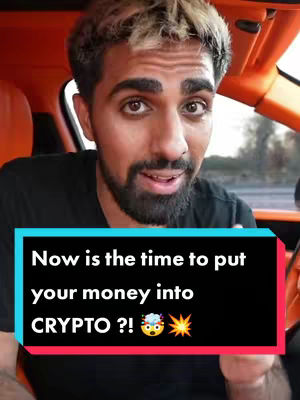 A man with lightened-blond hair is seated in the front seat of a vehicle with an orange interior, looking directly to the camera. Below him is a rectangular text overlay with white text on a black background. The image is brightly lit with natural light.