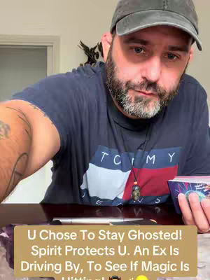 A man in a dark blue Tommy Hilfiger t-shirt and a baseball cap is holding a deck of cards, looking down. The image contains a yellow rectangle with white text overlay at the bottom with text.