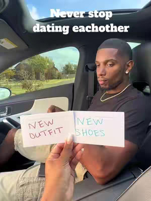 A man is seated in a car, holding a piece of paper divided into two sections. The left reads 'NEW OUTFIT' in red marker, and the right says 'NEW SHOES' in blue. The overlay text reads: 'Never stop dating eachother.'