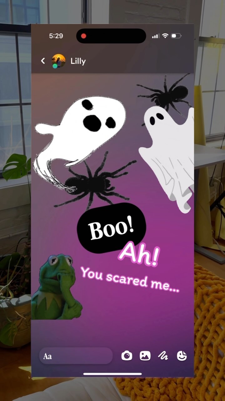 The image is a screenshot of a phone screen, with a Halloween-themed overlay. The background is a gradient of dark purple at the bottom, fading to a lighter purple at the top. Several animated elements are scattered across the screen: two white ghosts, two black spiders, and a Kermit the Frog character. Text bubbles are placed throughout that say 'Boo!', 'Ah!' in a cartoon-style font, and 'You scared me...' in a casual font.