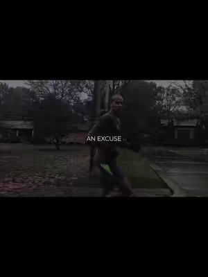 A video cover shows a man walking towards the camera in an outdoor setting. The environment appears to be a residential area, with trees, houses, and a sidewalk. The image has a slightly desaturated, perhaps vintage-look, with the man in motion, hinting at the video's content being energetic or active.