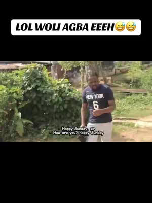 The image shows a man standing outdoors with a green, leafy background. He is wearing a dark blue t-shirt with the word 'NEW YORK' and the number '6' on it, paired with white pants. Above him is a white rectangular text overlay that reads 'LOL WOLI AGBA EEEH' with laughing emojis.