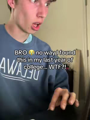 A young man with short hair looks surprised and concerned, with his mouth open. He is wearing a blue sweatshirt with white text on it. Text overlay on the image reads 'BRO 😭 no way I found this in my last year of college... WTF?!?' The background behind him is out of focus.
