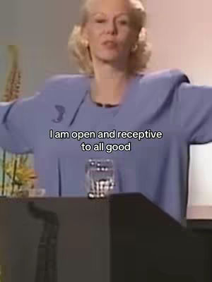 A woman with blonde hair stands behind a podium giving a speech. Text overlayed on the image reads: 'I am open and receptive to all good'.