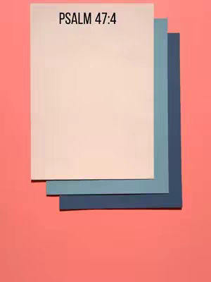 The cover image displays a layered composition of rectangular paper sheets against a solid pink backdrop. The topmost sheet is a light beige, followed by layers of blue and dark blue. The text overlay, "PSALM 47:4," is at the top of the light beige sheet.