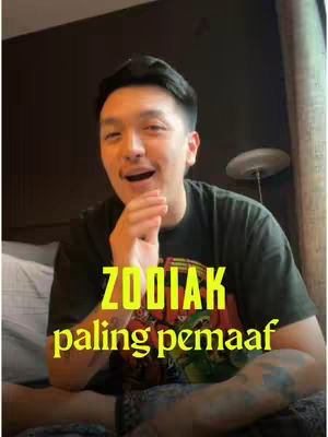 A man is seated indoors with a dark background, holding his hand near his mouth. Overlayed in yellow text is the phrase 'ZODIAK paling pemaaf'.