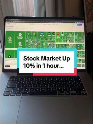 A laptop displaying a stock market chart with a text overlay. The laptop is open on a desk in front of a window. The top part of the screen shows market data with many stocks. The overlayed text reads, 'Stock Market Up 10% in 1 hour...'