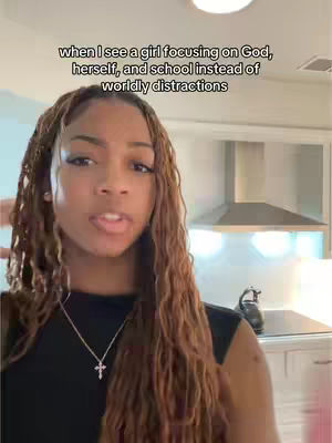The cover image features a woman with long, wavy brown hair, set against a blurred kitchen background. She wears a black top and a silver necklace with a cross pendant. Text overlays at the top of the image. The composition is a selfie-style shot.