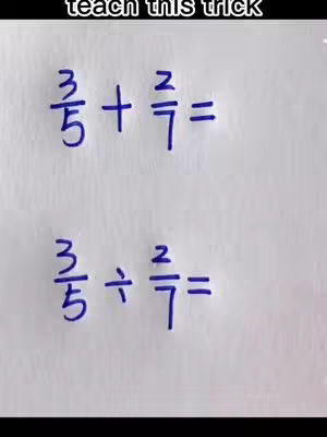 A white background is filled with handwritten mathematical equations. At the top, it reads 3/5 + 2/7 =, and below it, 3/5 ÷ 2/7 =. The text is written in dark blue. The image is well-lit, and the composition focuses entirely on the mathematical equations.
