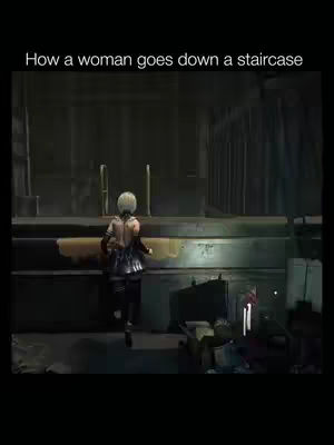 A screenshot from a video game where a character with white hair and a black outfit is walking down a staircase. The staircase is made of concrete, and the lighting is dim, creating a shadowed environment. There are some boxes and items on the ground.