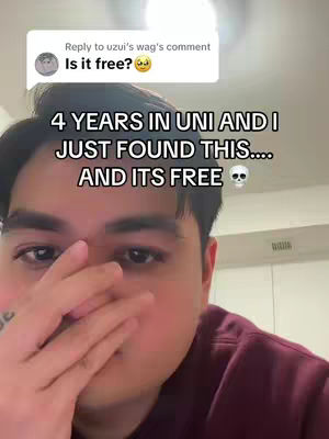 A selfie-style shot featuring a close-up of a young man's face. He has dark hair and is looking towards the camera. His hand is raised, partially obscuring his face. Overlayed text appears in a speech bubble and in a larger font below the bubble. The background is blurred, likely indicating an indoor setting with a neutral color palette.