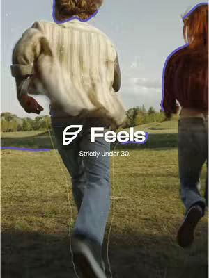 Two figures running in a grassy field, viewed from behind. The image is bathed in natural light and appears to be taken on a sunny day. The logo of the app, the name Feels, is displayed in the center of the frame. Additional text is also included.