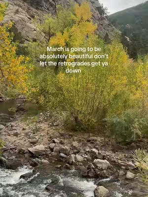 A landscape image featuring trees with yellow and green leaves next to a river. A rocky mountainside dominates the background. Overlayed on the image is white text.