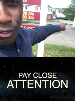 A man with a dark complexion points to the right, while looking toward the left of the frame. A text overlay at the bottom reads 'PAY CLOSE ATTENTION' in large, bold, capital letters, with a galaxy-like background.