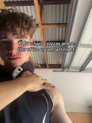 A young man with curly brown hair looks at the camera. Text over the face suggests a POV from that night of an overindulgent meal. The background shows a garage roof.