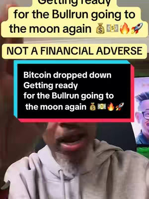 A man in a hoodie appears, speaking to the camera. Behind him, a screen shows a graphic design with the text 'Bitcoin dropped down' and other related information. The background hints at a room setting, with potential online content.