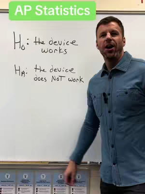 A man stands in front of a whiteboard with equations on it. He is looking at the camera excitedly.
