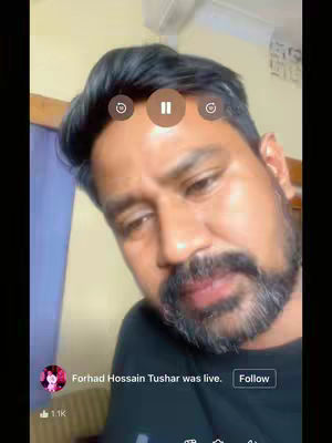 The image shows a close-up shot of a man with a concerned expression, likely a video still from a live stream. He has dark hair, a well-groomed beard, and is wearing a dark shirt. The background suggests a simple indoor setting. Overlaid on the image are live stream controls and a profile picture with a name, further indicating the live video context.