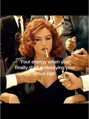 A woman with red hair and a cigarette in her mouth is surrounded by hands holding a lighter. Text overlayed says, "Your energy when you finally start embodying your venus sign".