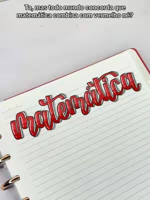 The cover image showcases a close-up of an open notebook featuring the word "Matemática" (Mathematics) written in bold, red, stylized lettering. The text is placed on a white, lined paper, and the notebook itself has a red border, suggesting a vibrant contrast. Above the main text, smaller text is present. The composition is simple, focusing on the text and its presentation within the notebook.