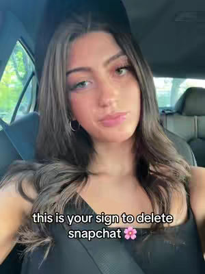 The cover image is a selfie taken from inside a car. A young woman with long, dark hair and fair skin is centered in the frame. She's wearing a black top and has a neutral expression. Text overlayed on the image reads: 'this is your sign to delete snapchat'. The background shows car windows, seats, and a suggestion of trees outside.