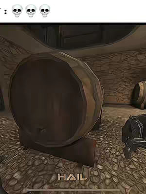 The image shows a first-person view from a video game with a large wooden barrel in the center, surrounded by a rocky environment. In the top left corner, there are three skull emojis. The word 'HAIL' is seen at the bottom in a golden font.