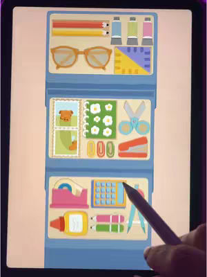 An iPad screen displaying a game interface mimicking a school supplies organizer. The background is light, the organizer is blue, and the compartments are white. Inside are illustrated objects like pencils, glasses, paint tubes, stamps, scissors, paperclips, tape, a calculator, and glue. A hand holding a stylus is visible, interacting with the screen.