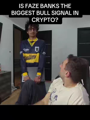 Two young men inside a room are shown, one in a jersey, and other in a chair. Text overlayed on the top that says ‘Is Faze Banks the biggest bull signal in crypto?’